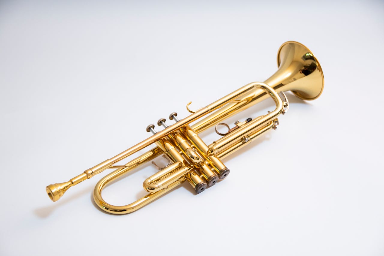 about-02 Close-up of a shiny gold trumpet isolated on a white background.